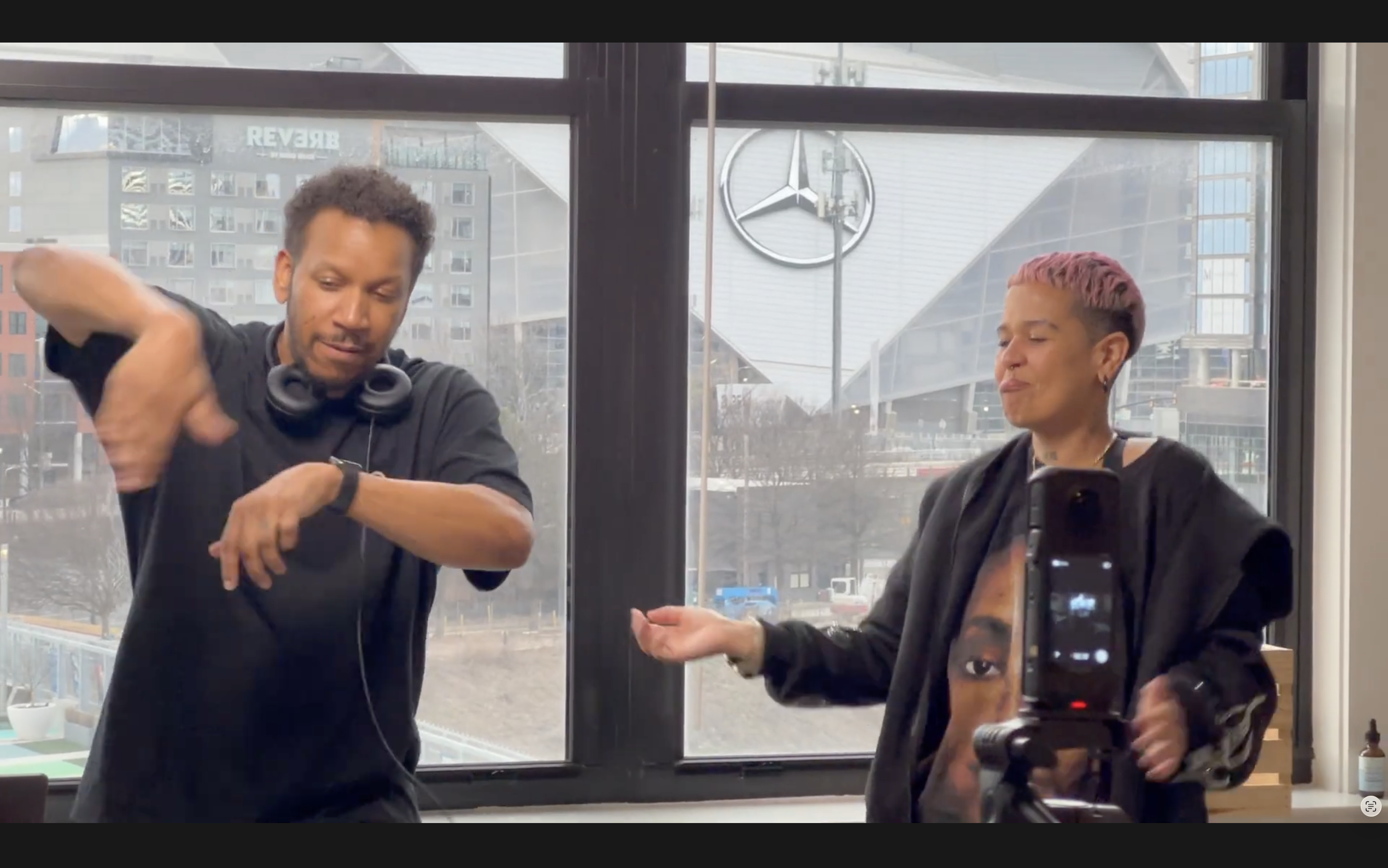 Jazz Ting Radio — Dell Harris at turntables, Mercedes-Benz Stadium visible through floor-to-ceiling windows